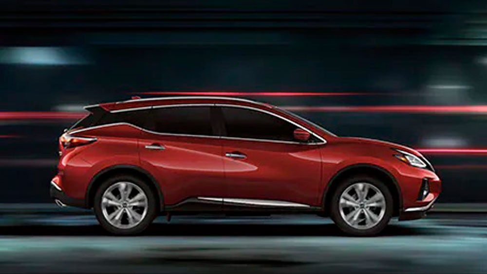 2023 Nissan Murano shown in profile driving down a street at night illustrating performance. | Granite Nissan in Rapid City SD